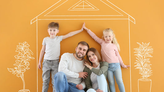 Family standing in front of icon of house